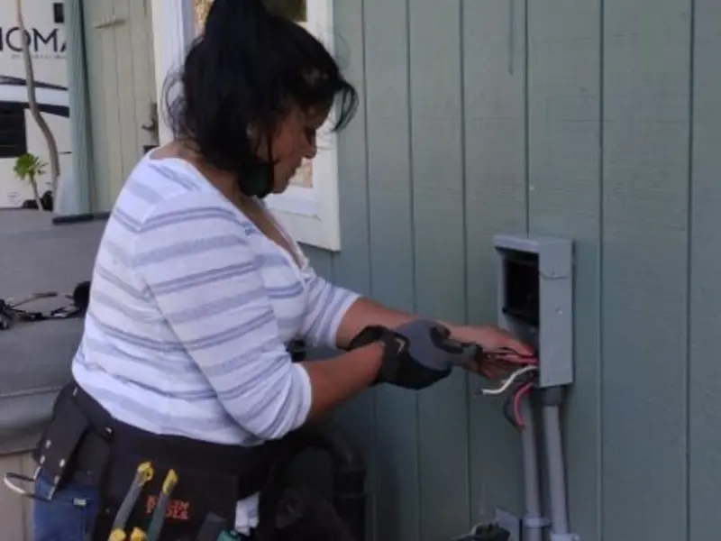 Licensed electrician wiring an exterior subpanel in Evergreen Park
